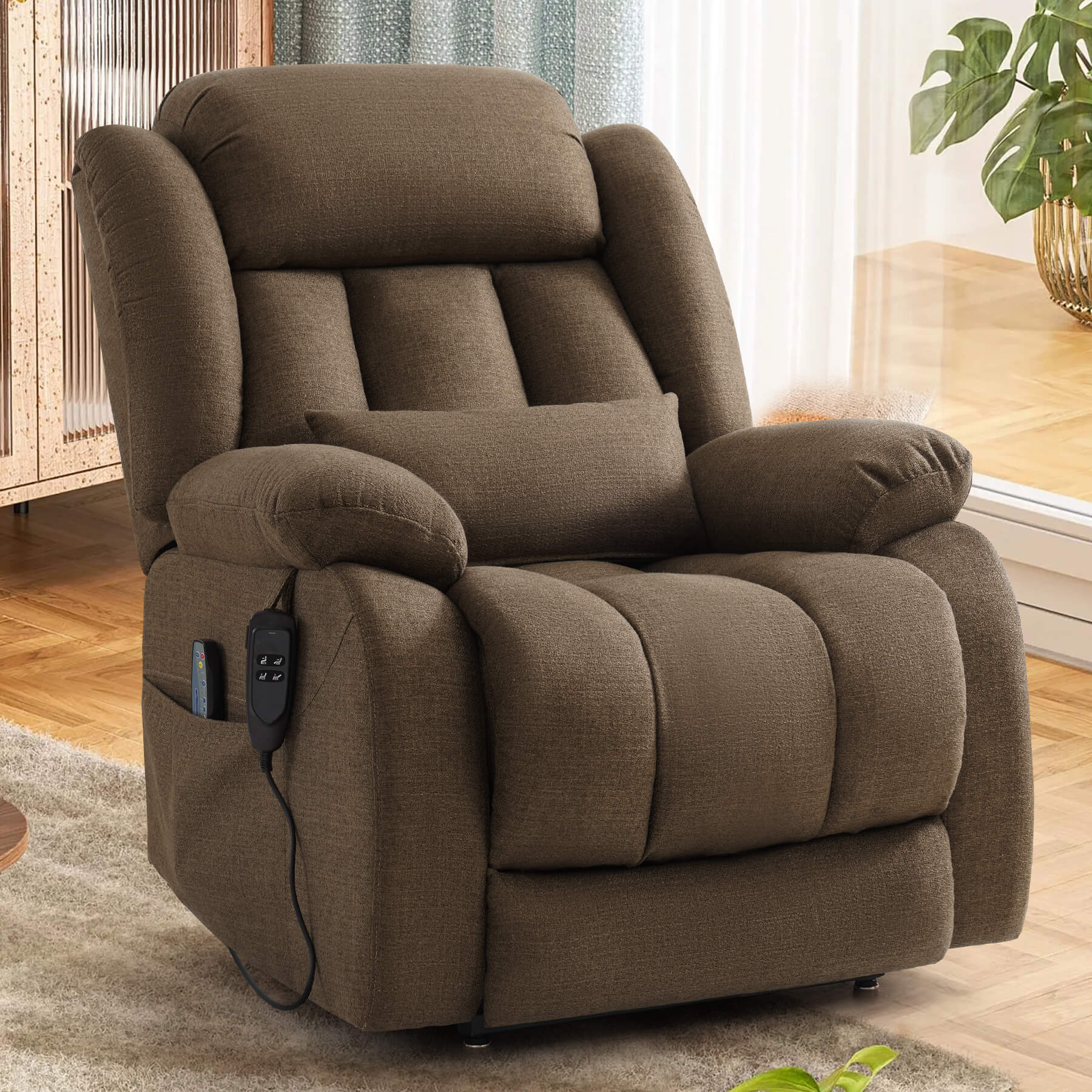 A brown upholstered recliner chair with a matching lumbar pillow, shown in an indoor room. A small control panel is attached to the side of the chair.