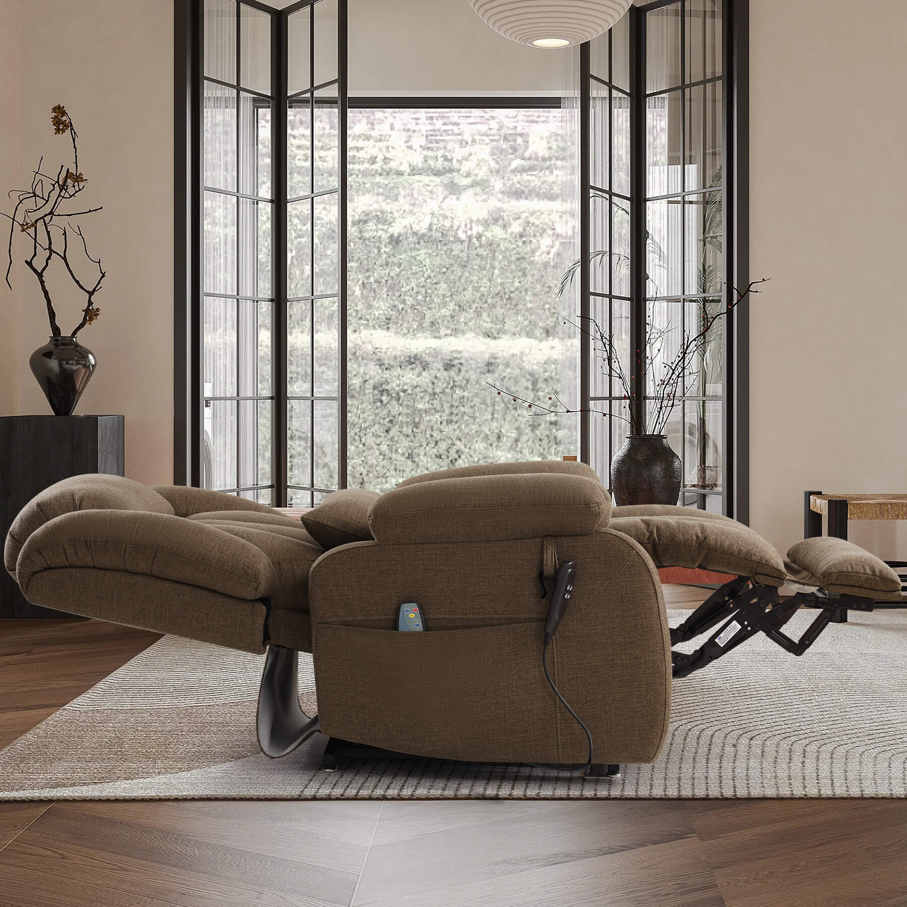 A brown fabric recliner chair with extended footrests and a matching headrest cushion, shown in a fully reclined, flat position in a modern living room.