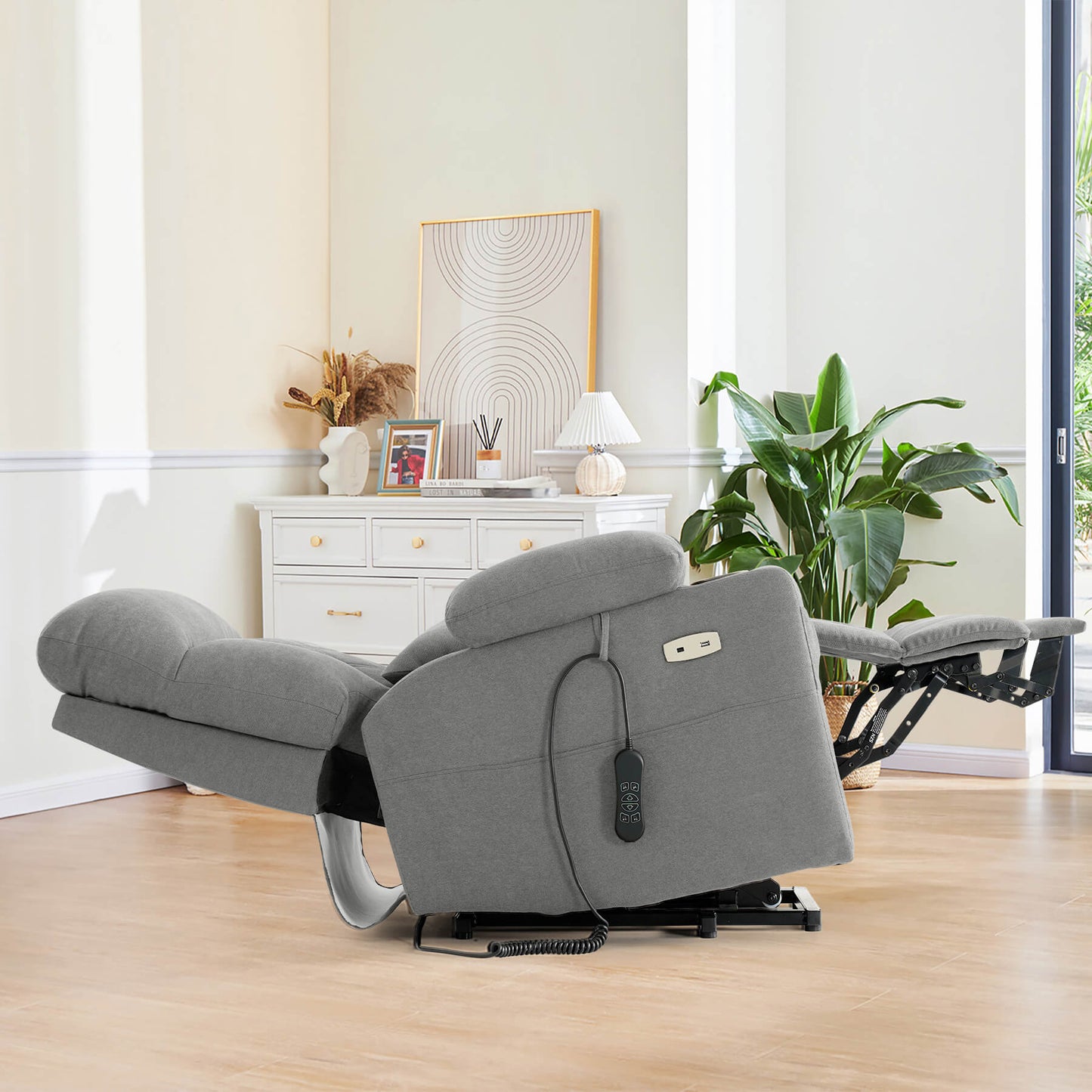 A light gray recliner positioned at zero-gravity angle in a modern living room.